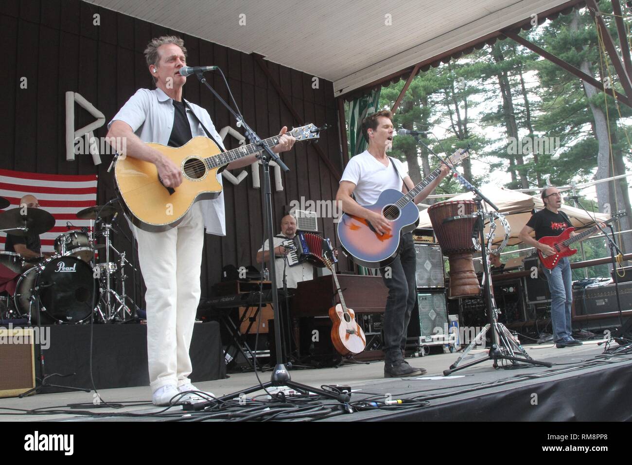 Musicians Michael and Kevin Bacon are shown performing on stage during