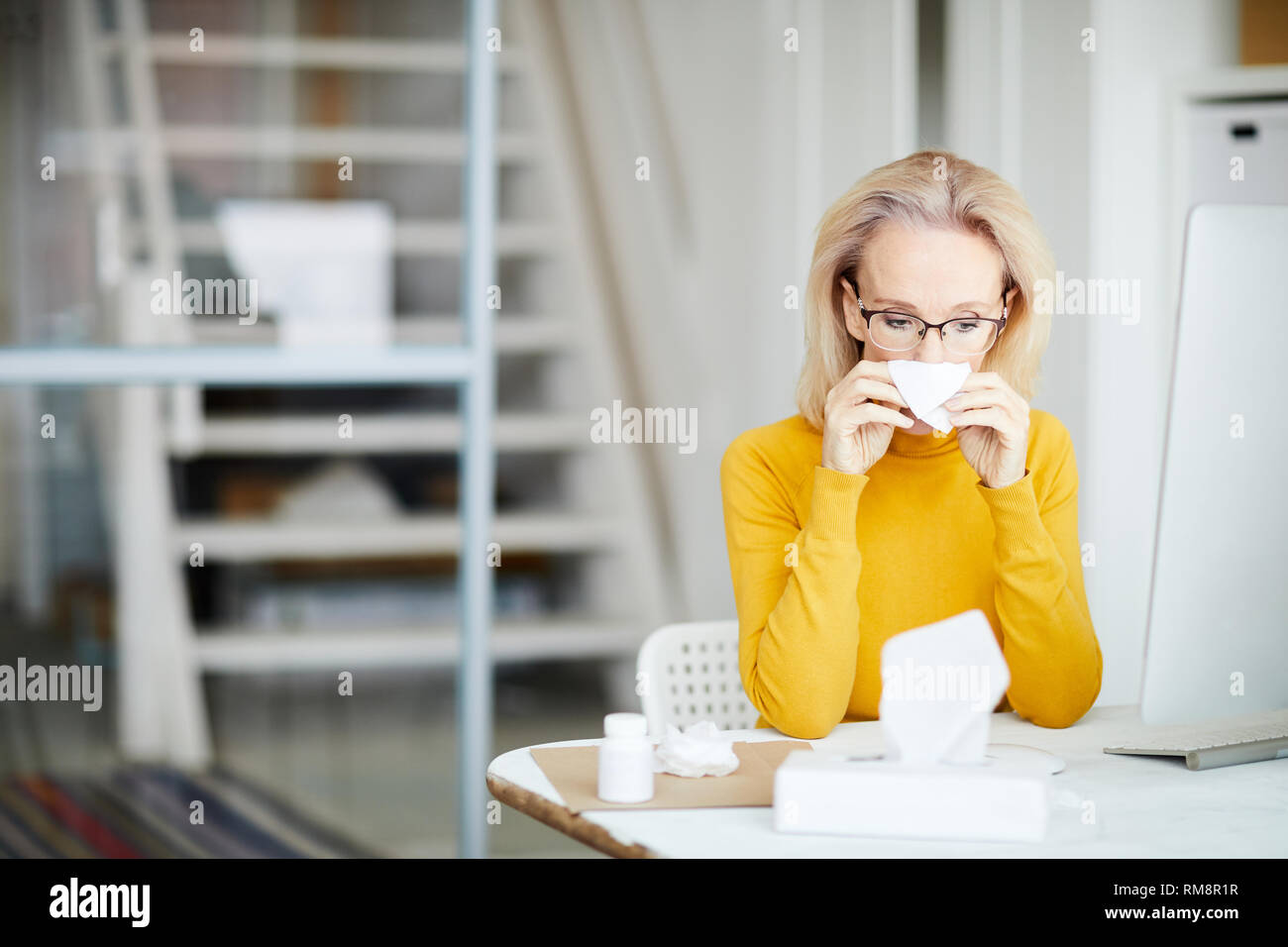 Sick Businesswoman at Work Stock Photo