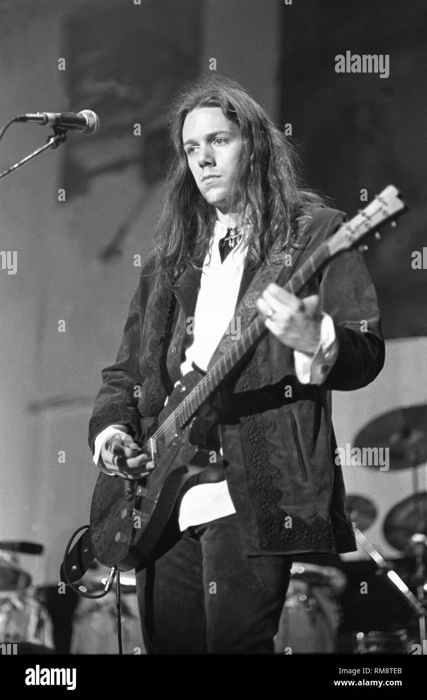 The Black Crowes guitarist RichRobinson is shown singing on stage