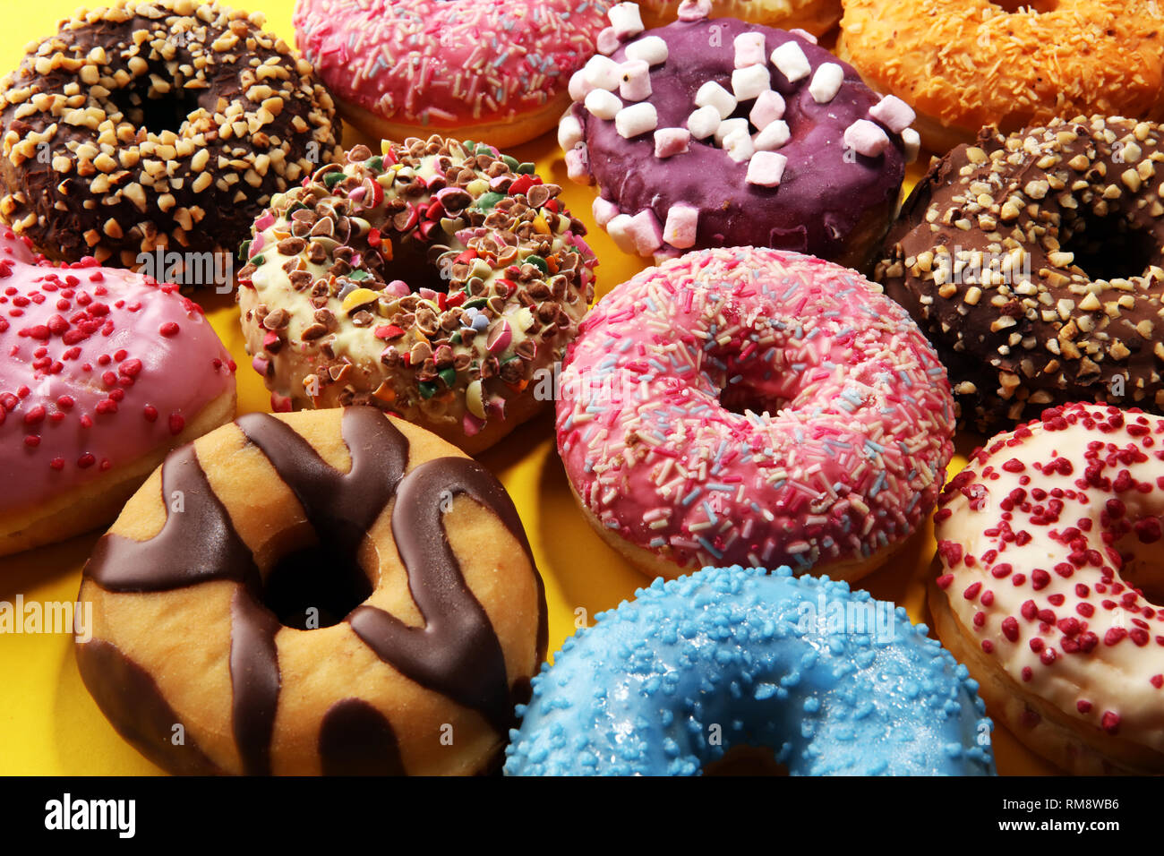 assorted donuts with chocolate frosted, pink glazed and sprinkles ...