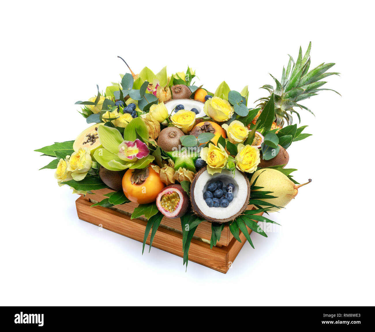 Wooden box with lots of exotic fruits and flowers isolated on white ...