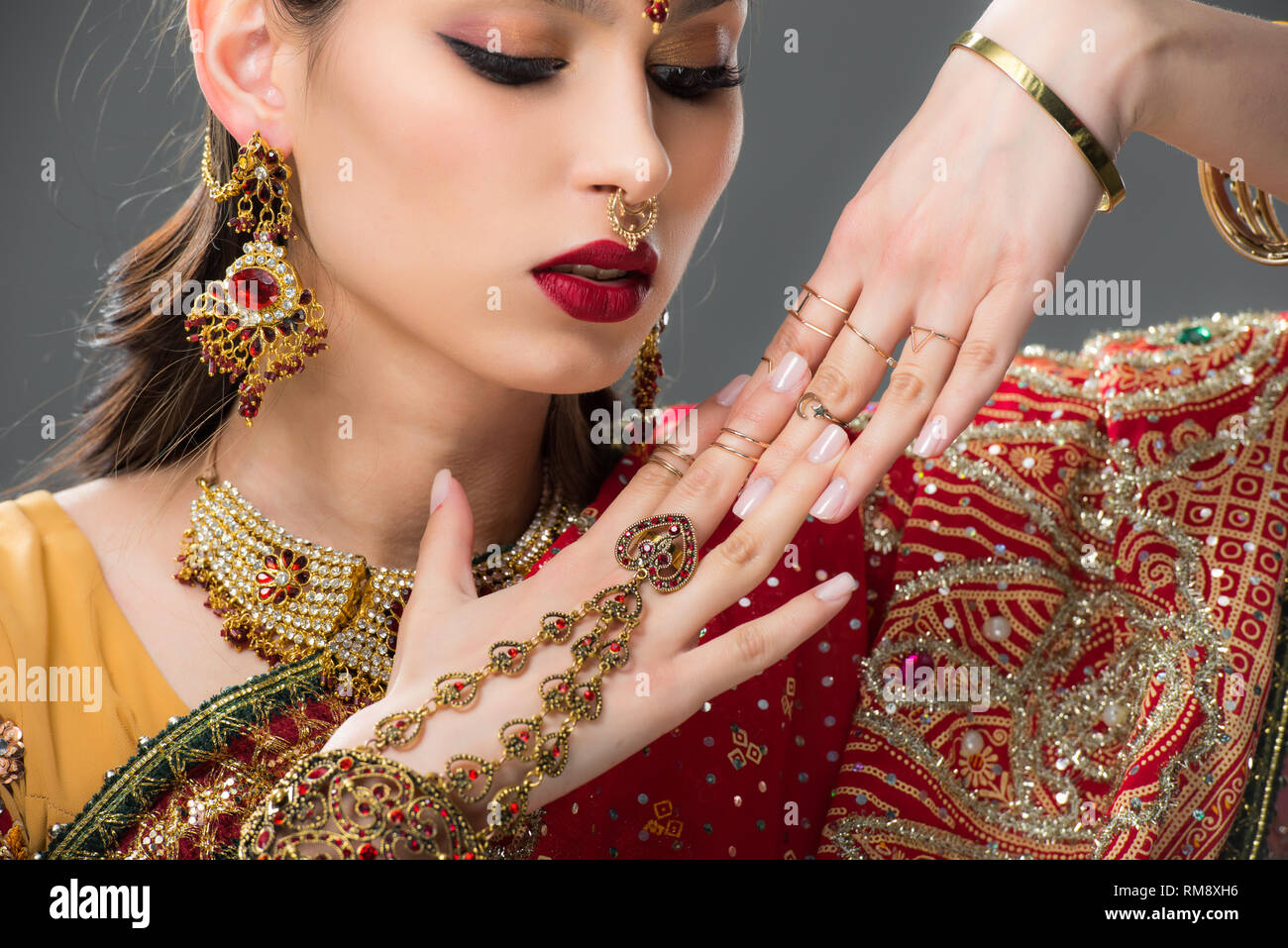 beautiful indian woman in sari and accessories on hands, isolated on grey Stock Photo