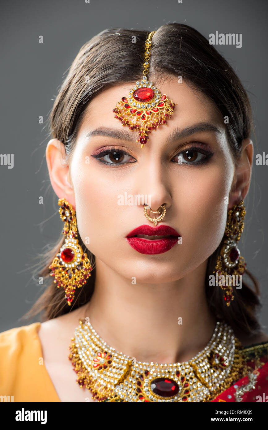attractive indian woman in traditional bindi, isolated on grey Stock Photo