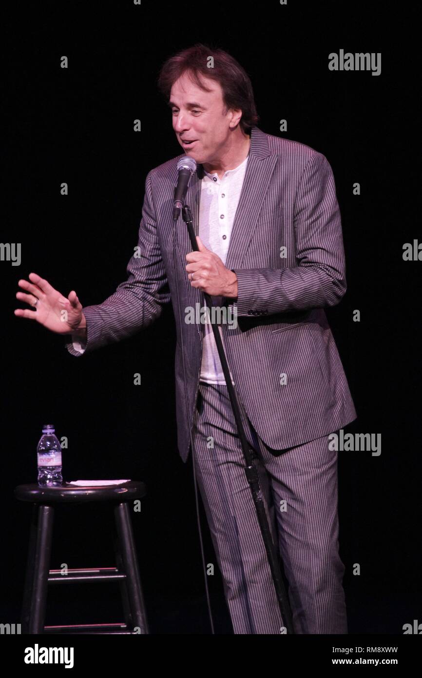 Comedian Kevin Nealon is shown performing on stage during a 'live' concert appearance. Stock Photo