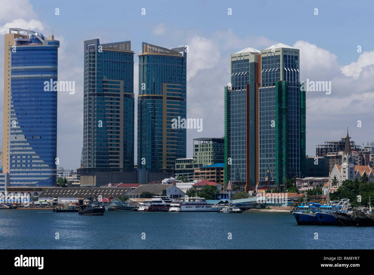 TANZANIA Daressalaam, bay, new apartment tower, Azam ferry terminal and catholic St. Joseph cathedral, built during german colonial time Stock Photo