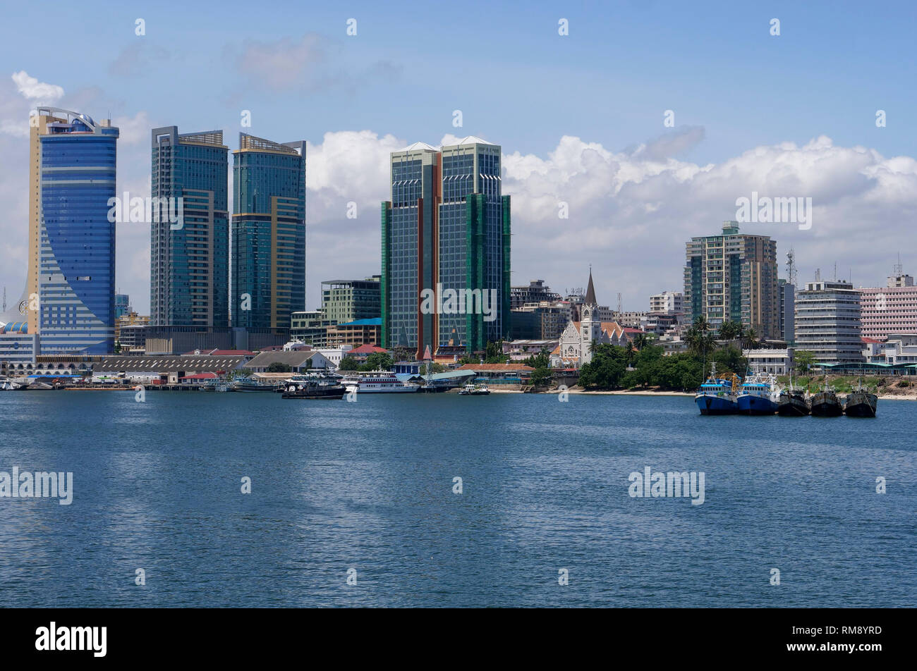 TANZANIA Daressalaam, bay, new apartment tower, Azam ferry terminal and catholic St. Joseph cathedral, built during german colonial time Stock Photo