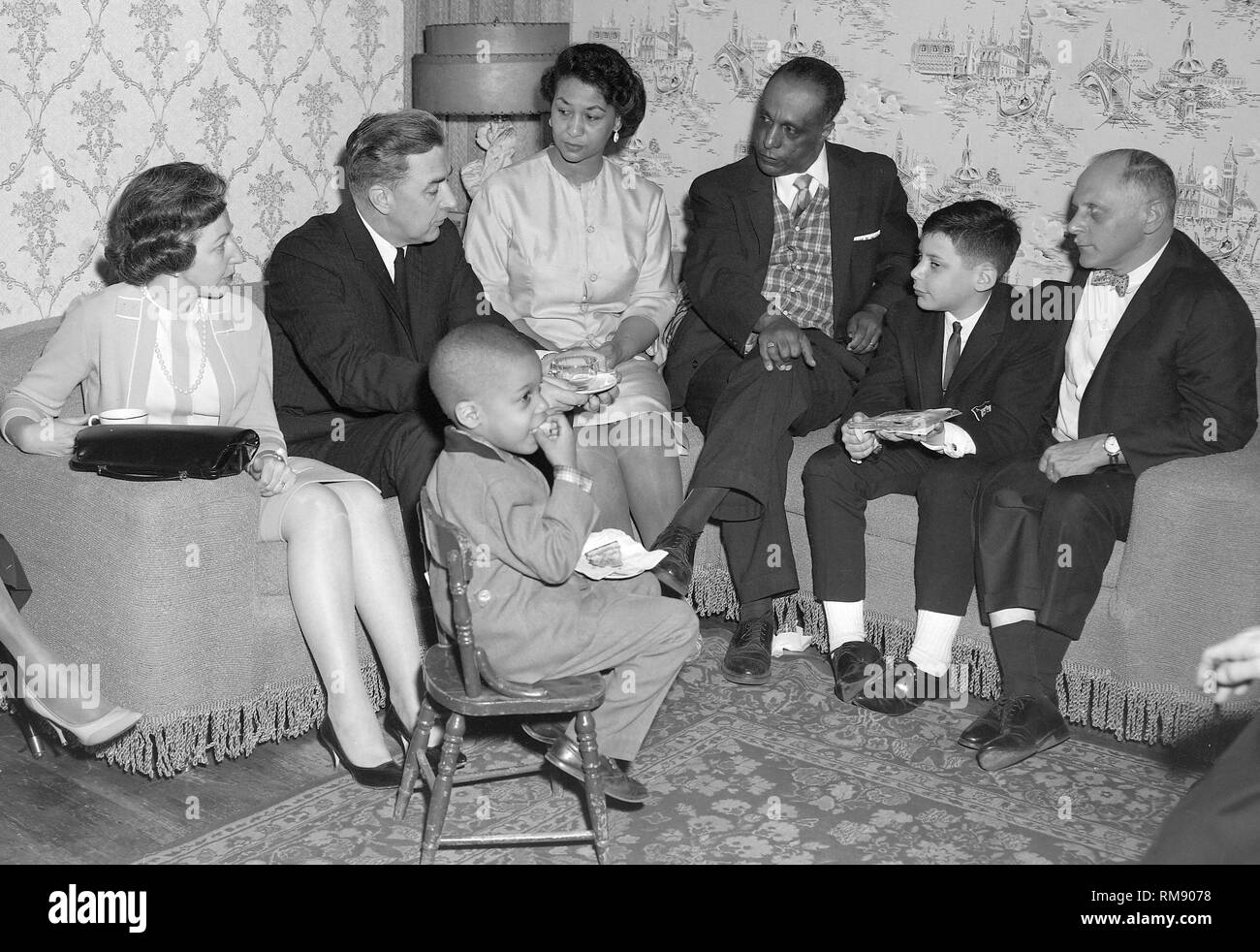 Presidential candidate Sen. Eugene McCarthy visits with an African American family on Chicago’s South Side during the 1964  campaign. Stock Photo