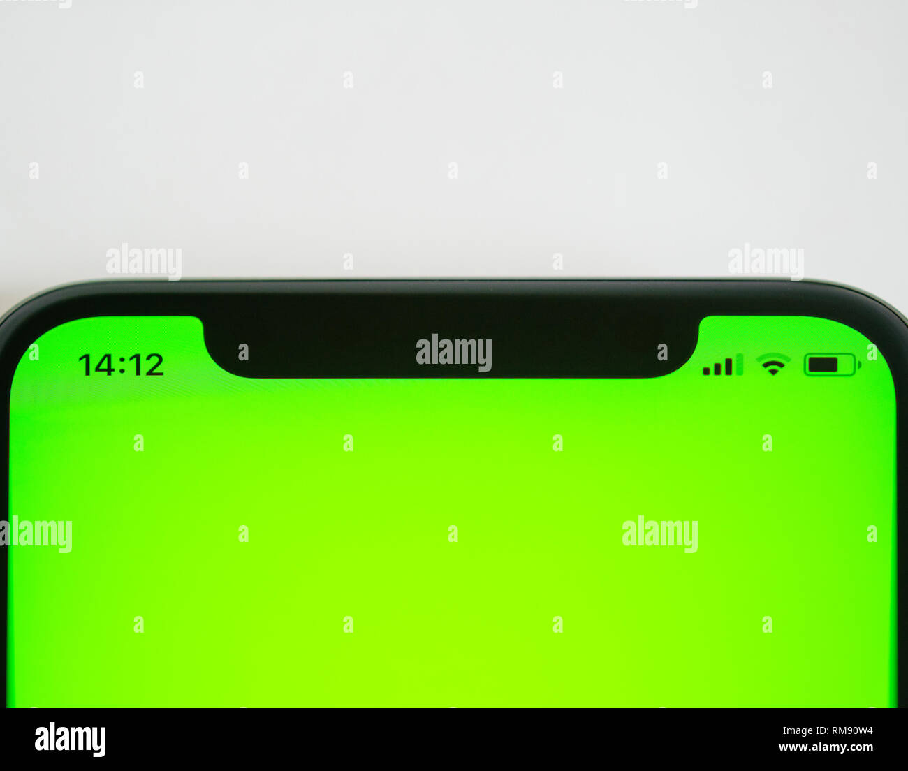 Smartphone detail with chroma green screen and icons for the current hour, battery charge wi-fi and network lte signal Stock Photo