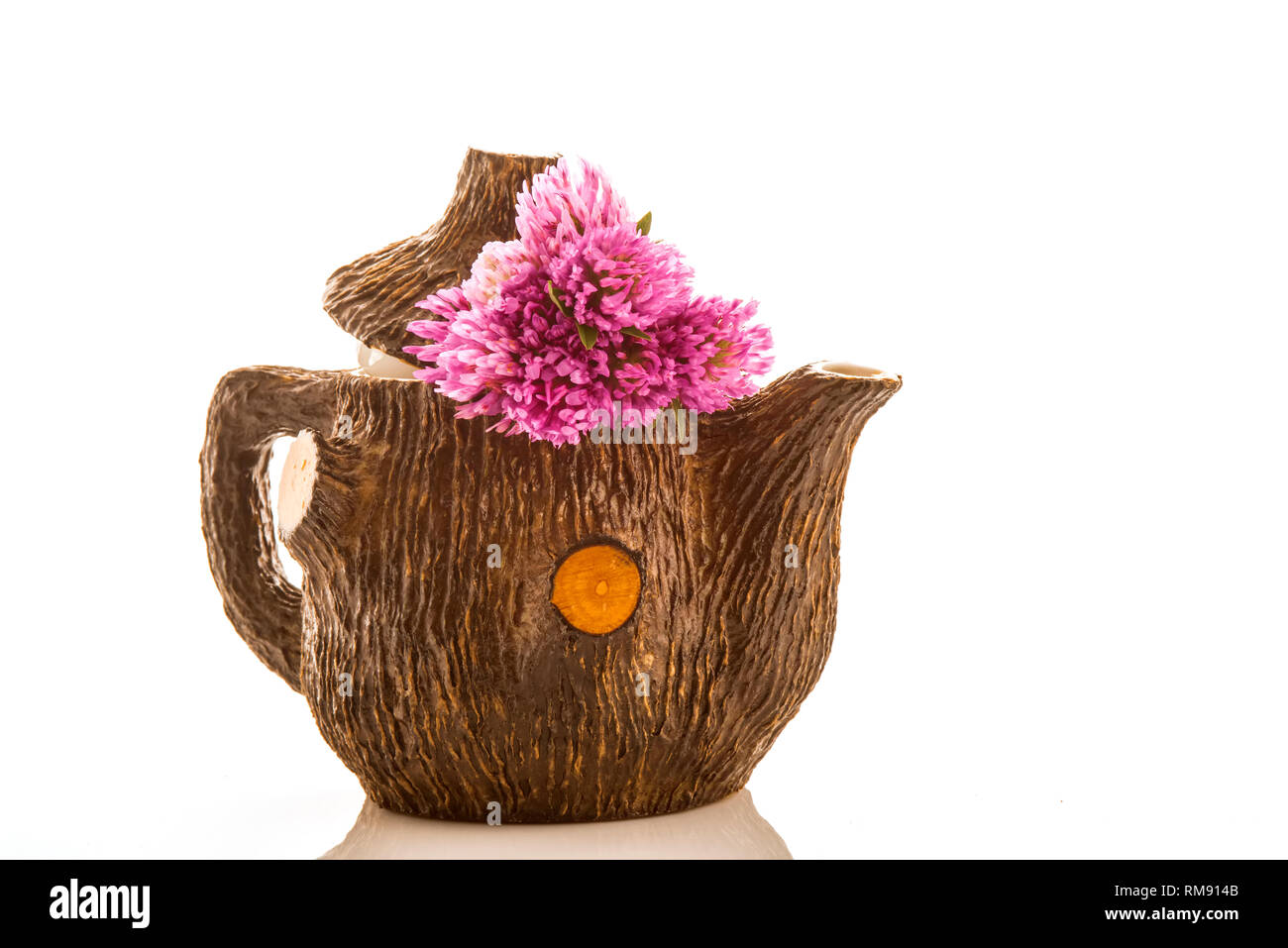 Teapot and bouquet of red clovers  isolated on white background Stock Photo