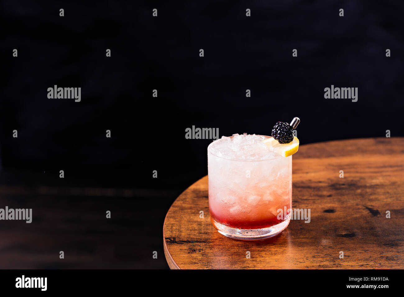 Refreshing Blackberry Gin Bramble on a Table Stock Photo