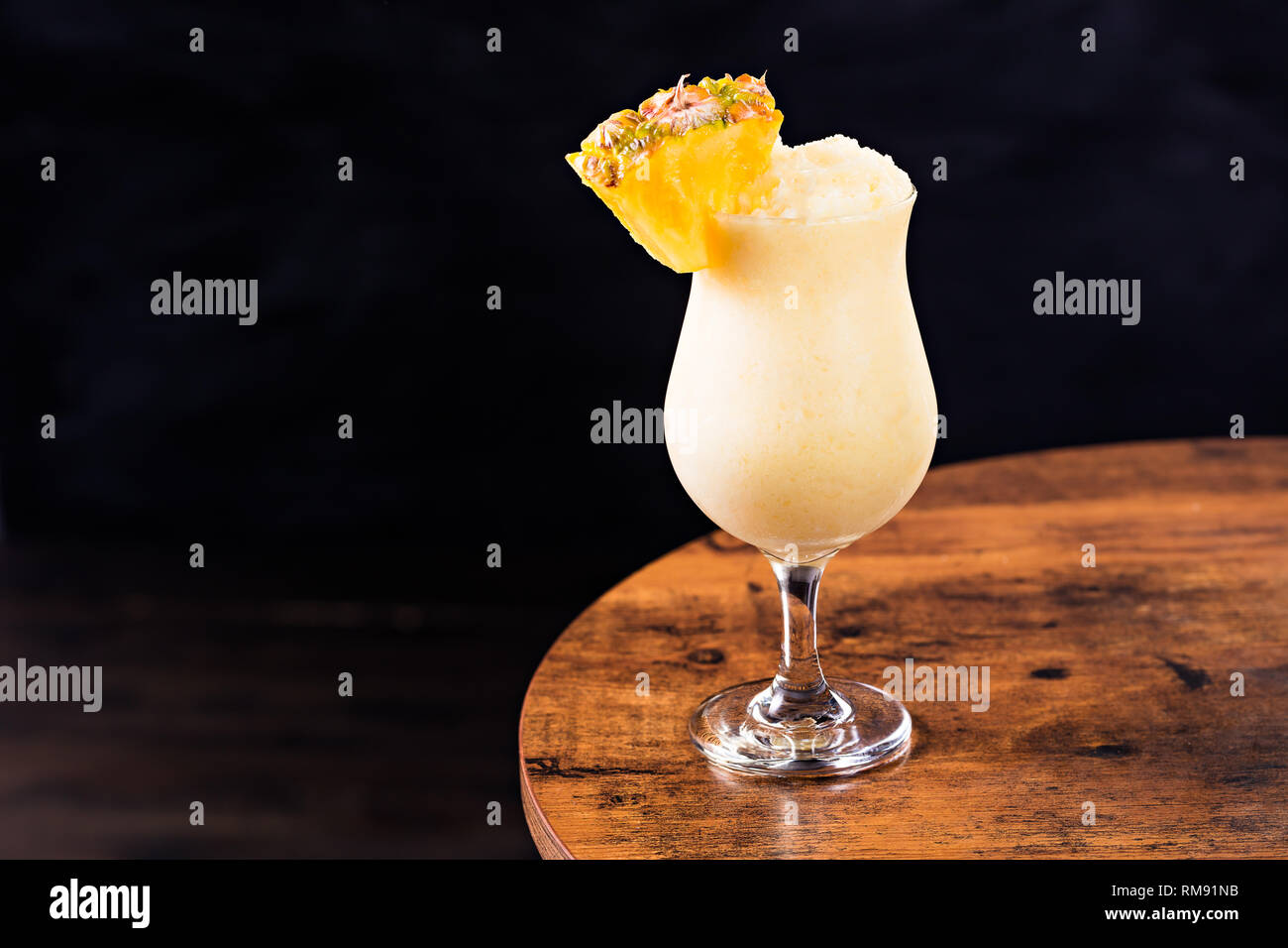 Refreshing Rum Pina Colada Cocktail on a Table Stock Photo