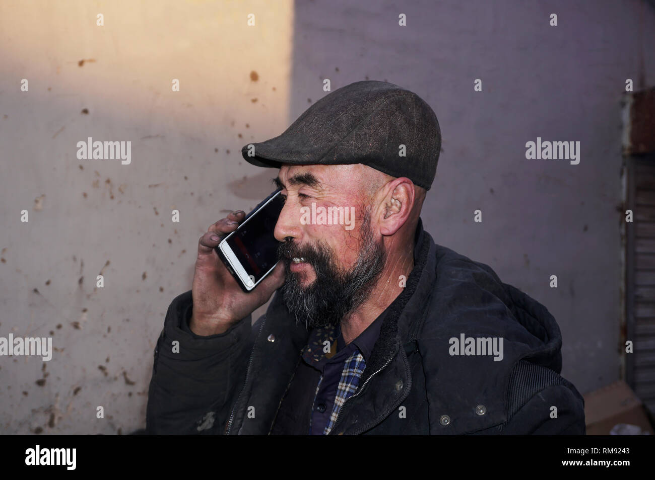 Using mobile phone Asian lod man. Stock Photo