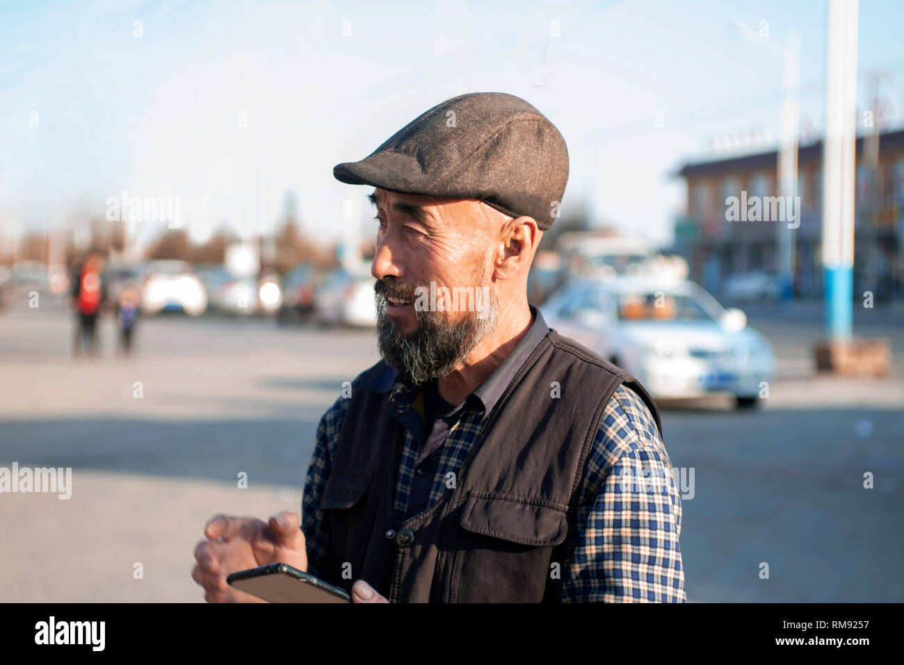 Using mobile phone Asian lod man. Stock Photo