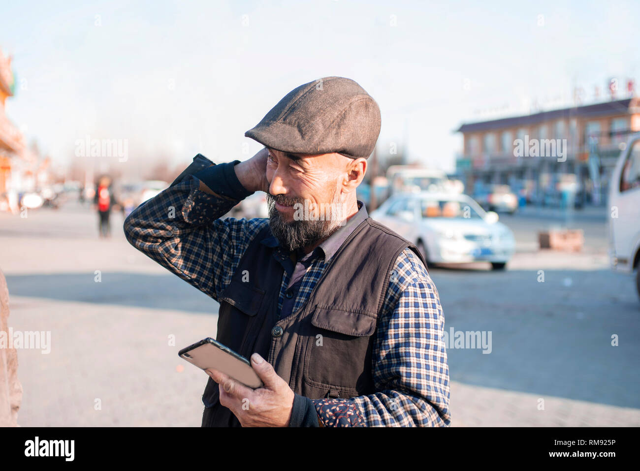 Using mobile phone Asian lod man. Stock Photo