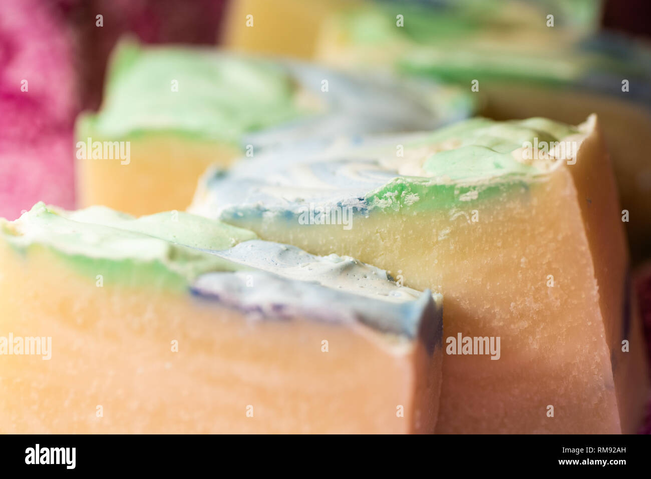 Multiple bars of hand crafted soap with colorful tops. Stock Photo