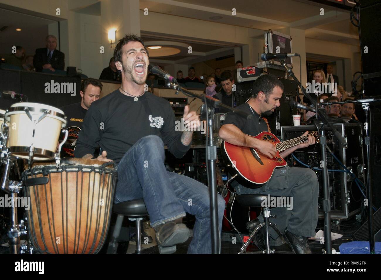 Godsmack frontman and songwriter Sully Erna is shown performing with the band in between periods at a Boston Bruins Hockey game. Stock Photo