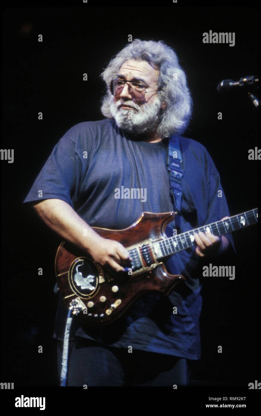 Singer, songwriter and guitarist Jerry Garcia of the Grateful Dead is shown performing on stage during a 'live' concert appearance. Stock Photo