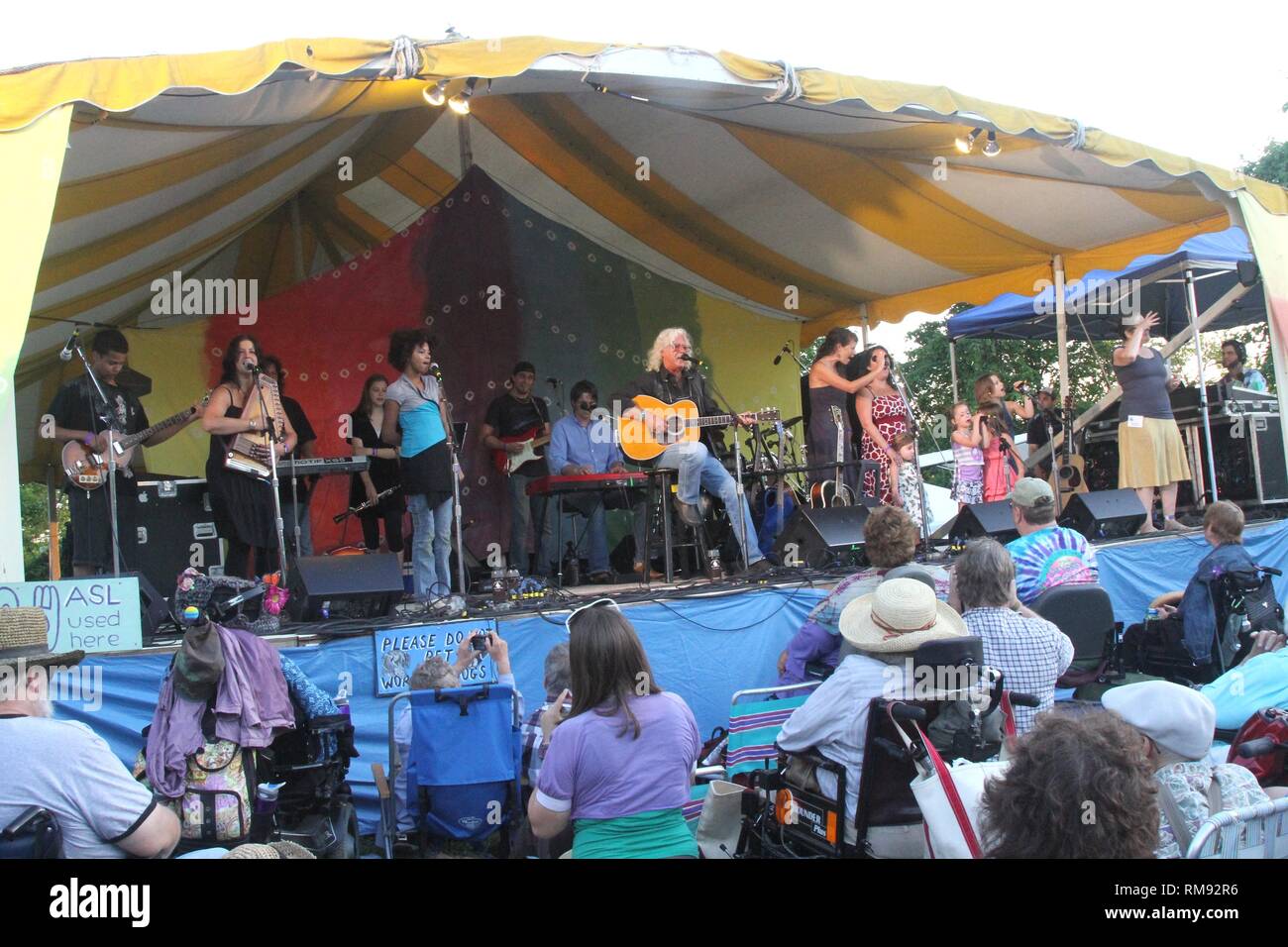 Arlo Guthrie & the Family Band are shown performing together on stage. Stock Photo