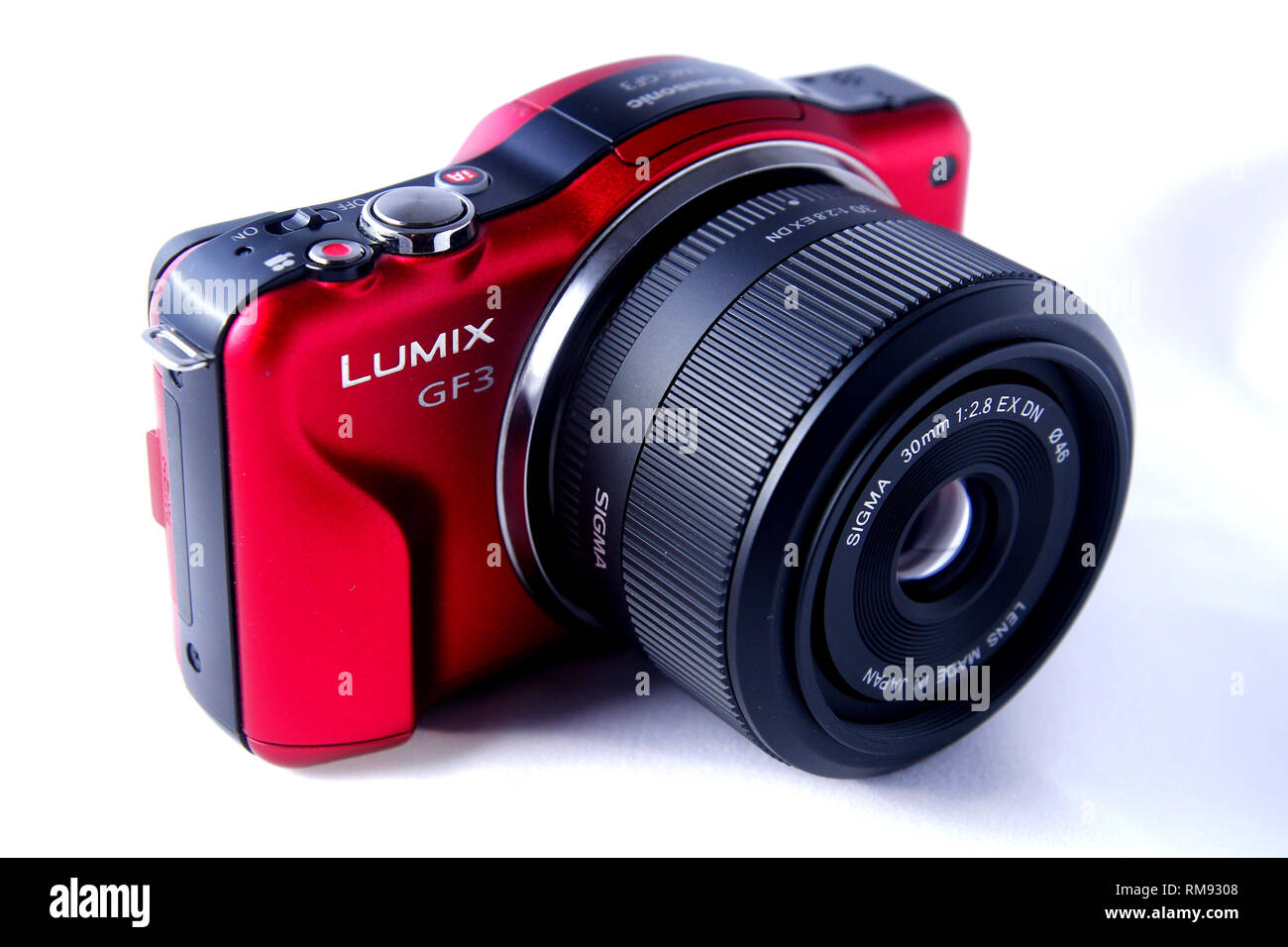 ANTIPOLO CITY, PHILIPPINES - FEBRUARY 3, 2019: A red digital mirrorless camera shot on white background. Stock Photo