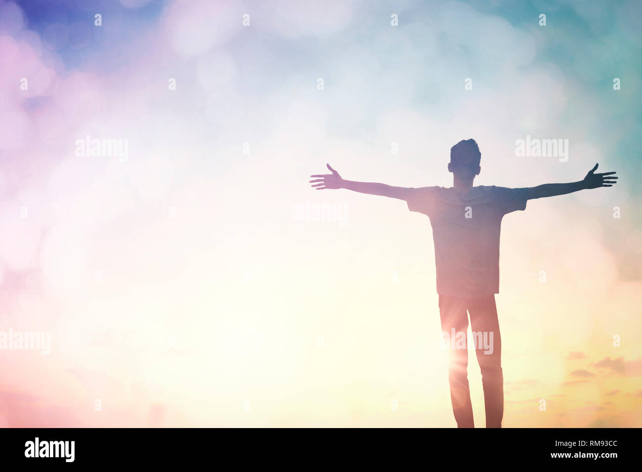 Silhouette of man with raised hands over blur cross concept for religion,  worship, prayer and praise Stock Photo - Alamy