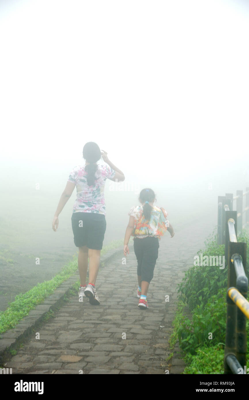 Mother and daughter walking to Sinhagad fort, Pune, Maharashtra, India, Asia, MR#364 Stock Photo