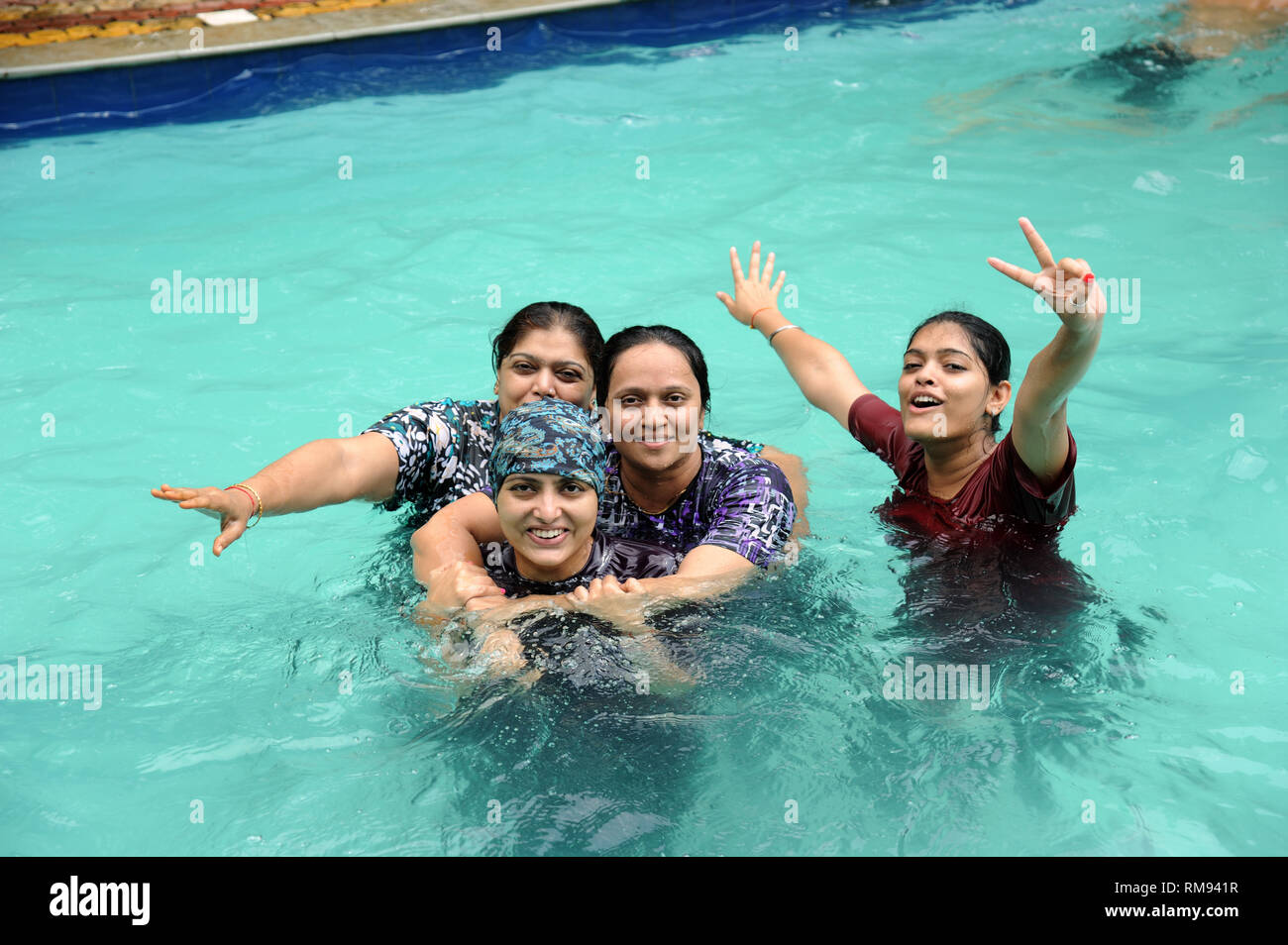 Mother and daughter in swimming pool, raigad, Maharashtra, India, Asia MR#364 Stock Photo