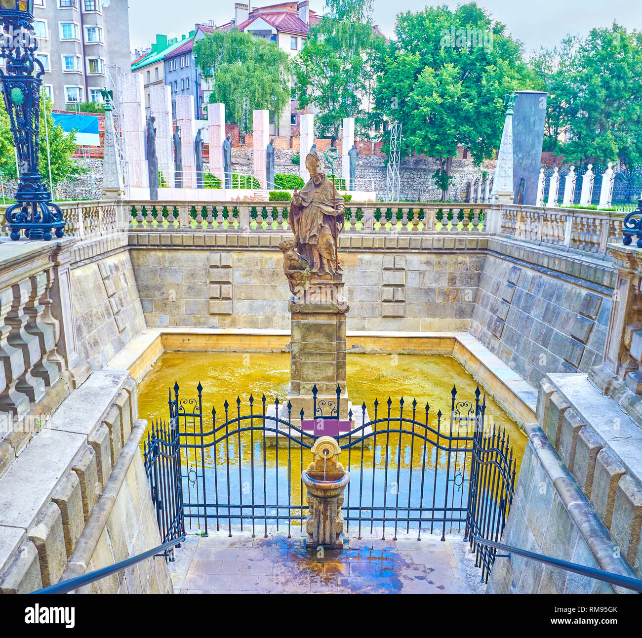 The Holy Water spring of the fountain of St Stanislaus located at the courtyard of St Michael and St Stanislaus Church in Krakow, Poland Stock Photo