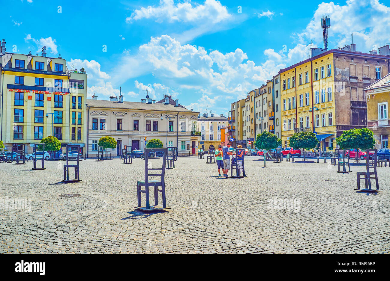 KRAKOW, POLAND - JUNE 21, 2018: Walk along the Empty Chairs memorial of Jewish victims of World War 2, located in Ghetto Heroes Square, on June 21 in  Stock Photo