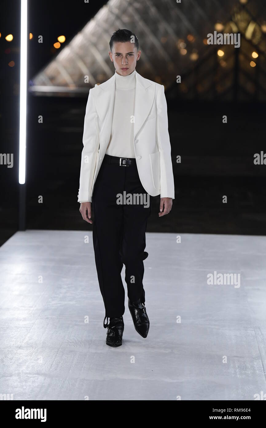 Louis Vuitton Ready to Wear Menswear Paris A W Blonde shirtless male model  wearing a white nylon vest black trousers and gloves Stock Photo - Alamy