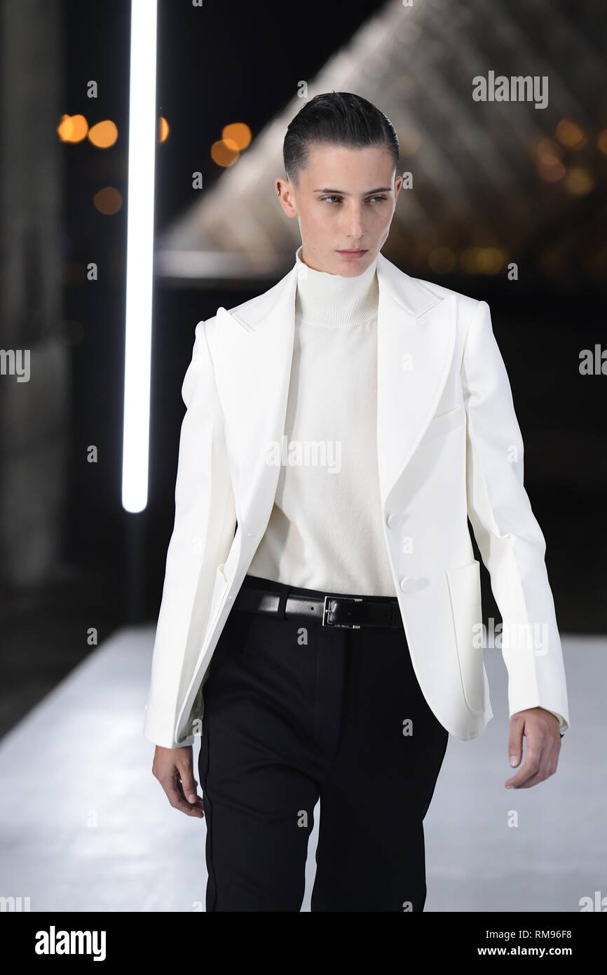 Louis Vuitton Ready to Wear Menswear Paris A W Blonde shirtless male model  wearing a white nylon vest black trousers and gloves Stock Photo - Alamy