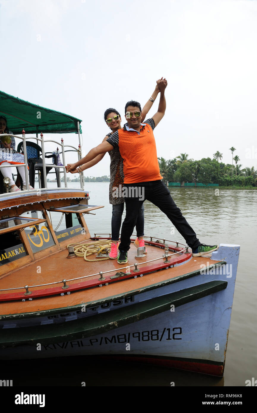 couple posing on deck of boat backwater, Munnar, Kerala, India, Asia, MR#801B, MR#802B Stock Photo