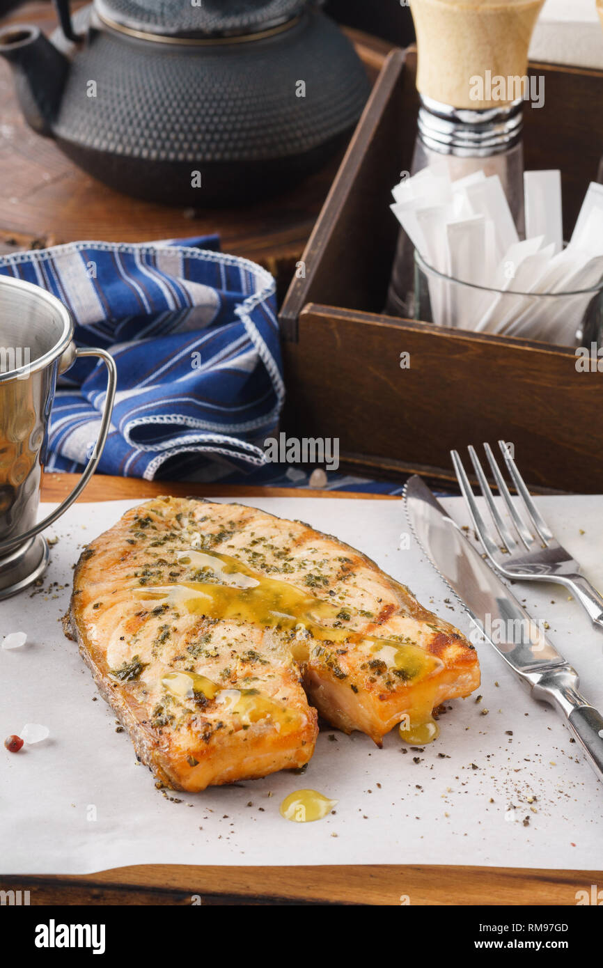 Roasted salmon steak with lemon and honey mustard sauce on a serving