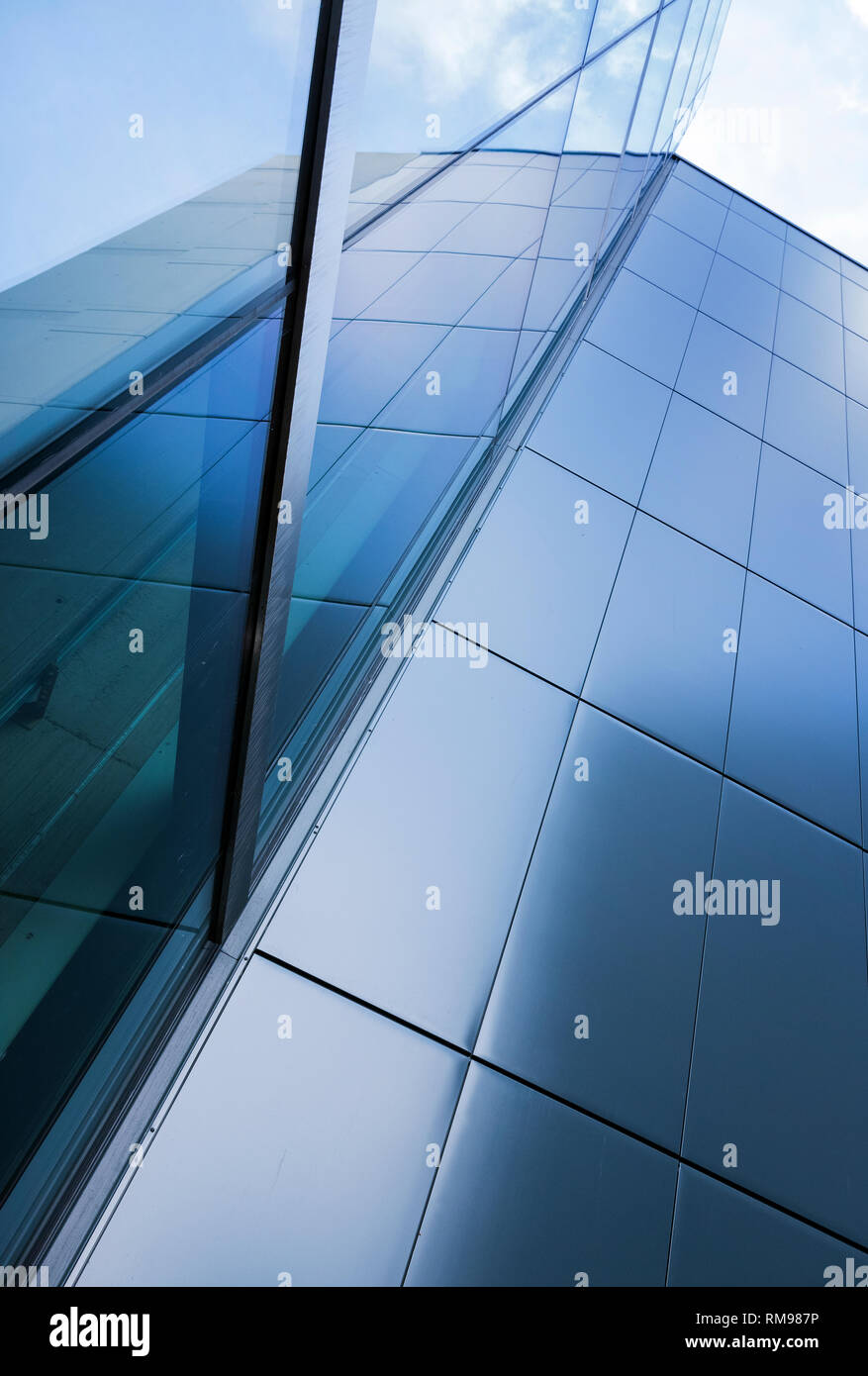 detail of modern office building with glass and steel reflecting blue ...
