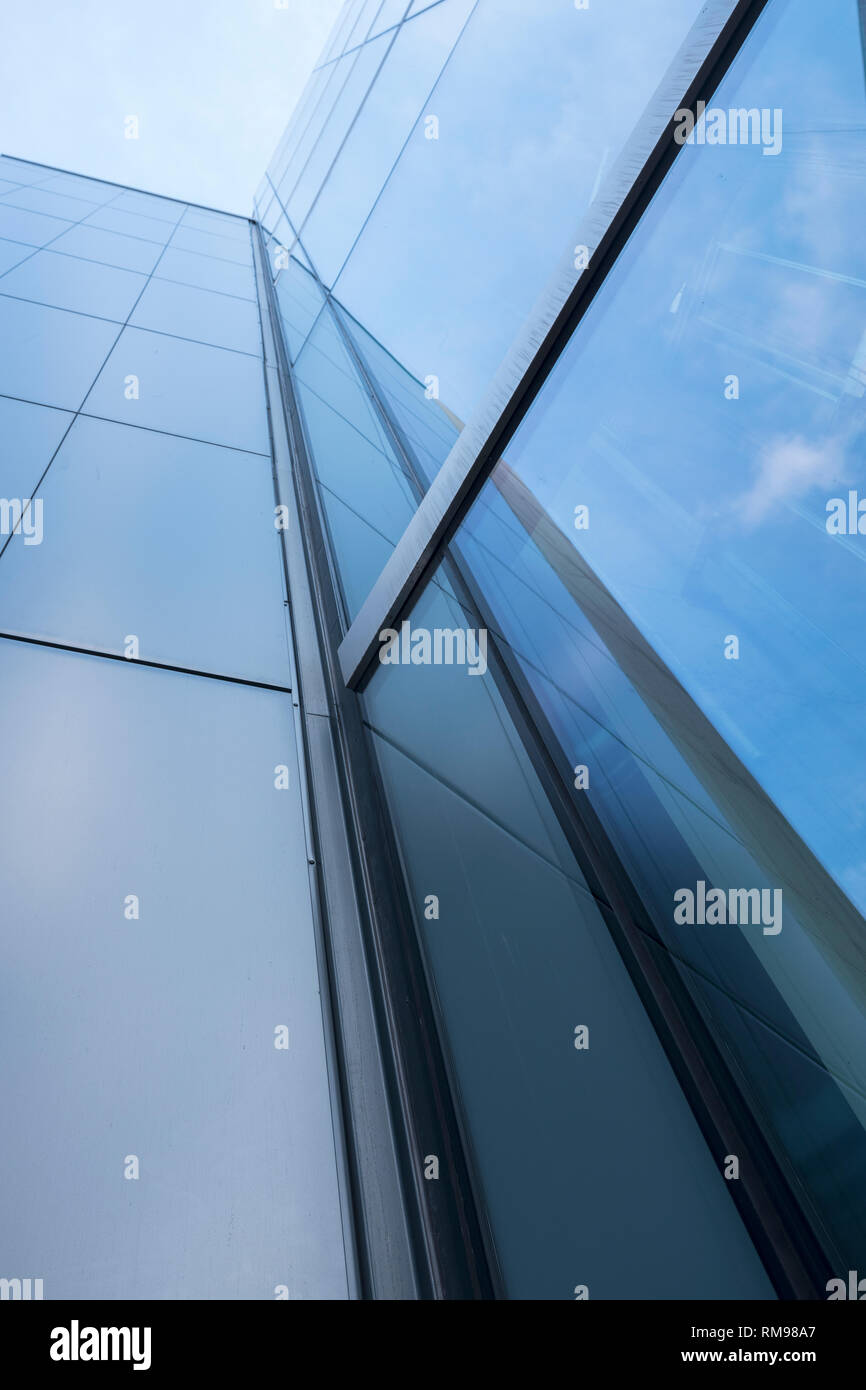 detail of modern office building with glass and steel reflecting blue ...