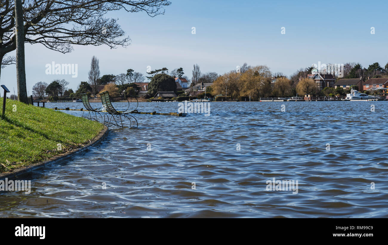 Oulton Broad, Suffolk, England, UK - April 05, 2018: Flooded benches on the shore of the Oulton Broad Stock Photo