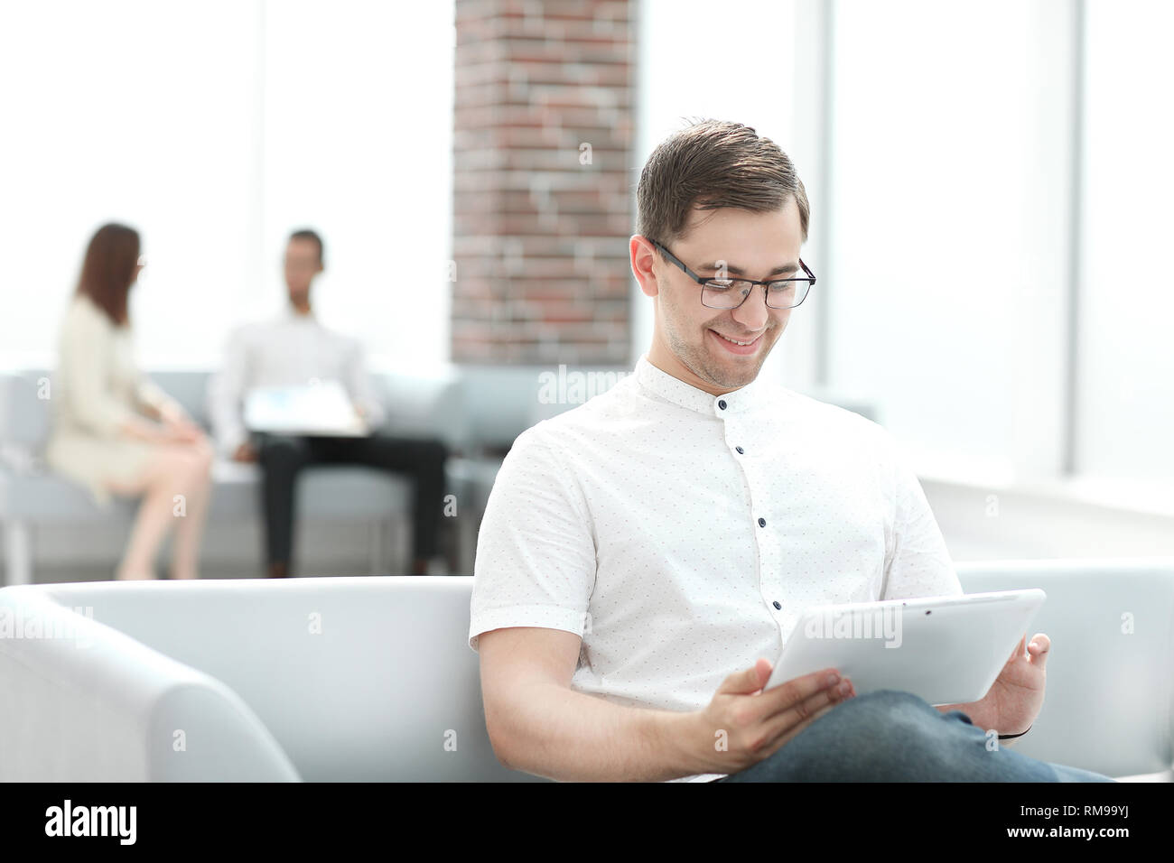 modern man uses a digital tablet for reading Stock Photo