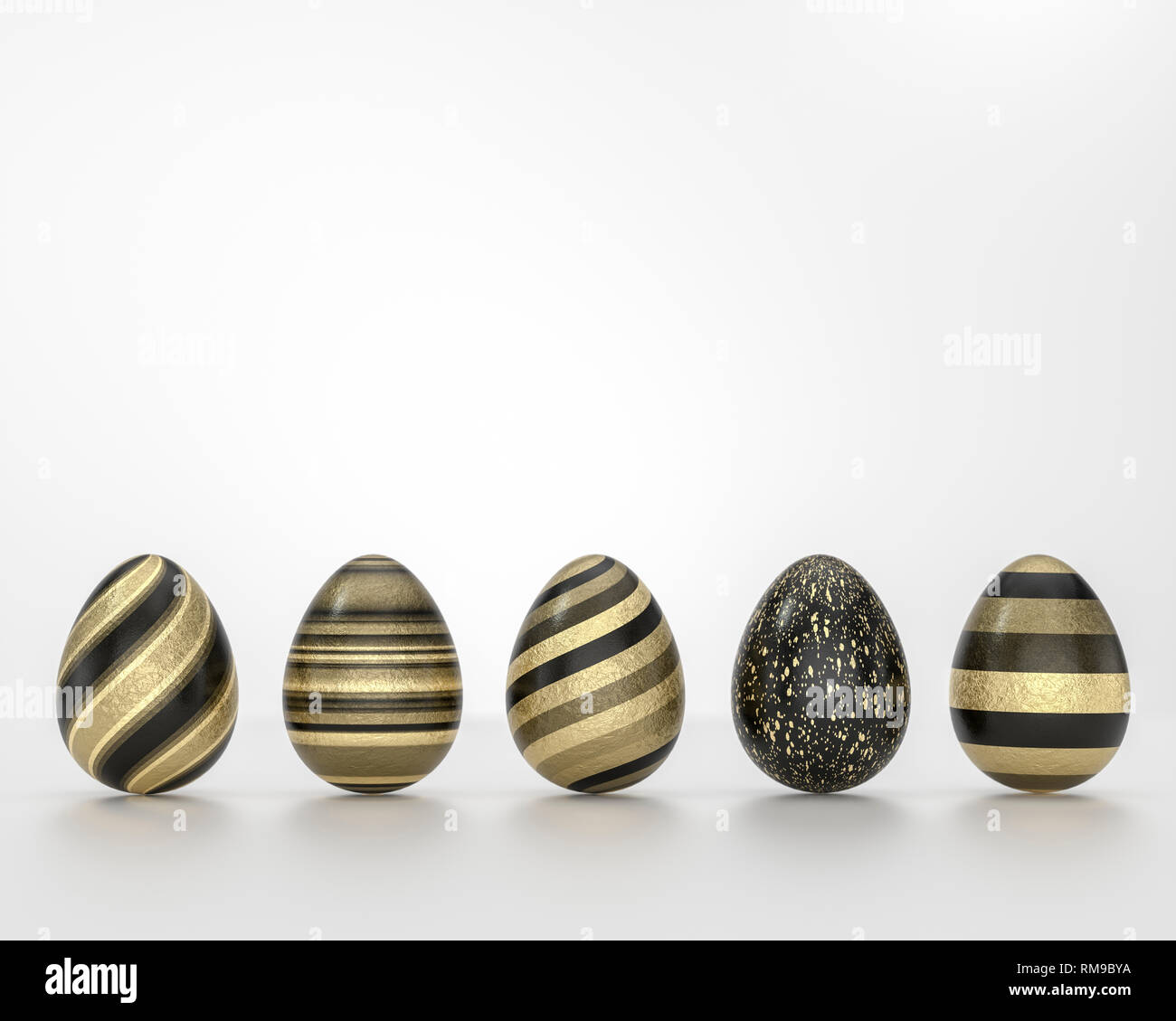 Row of black and gold Easter eggs, balanced on its blunt end on grey ...