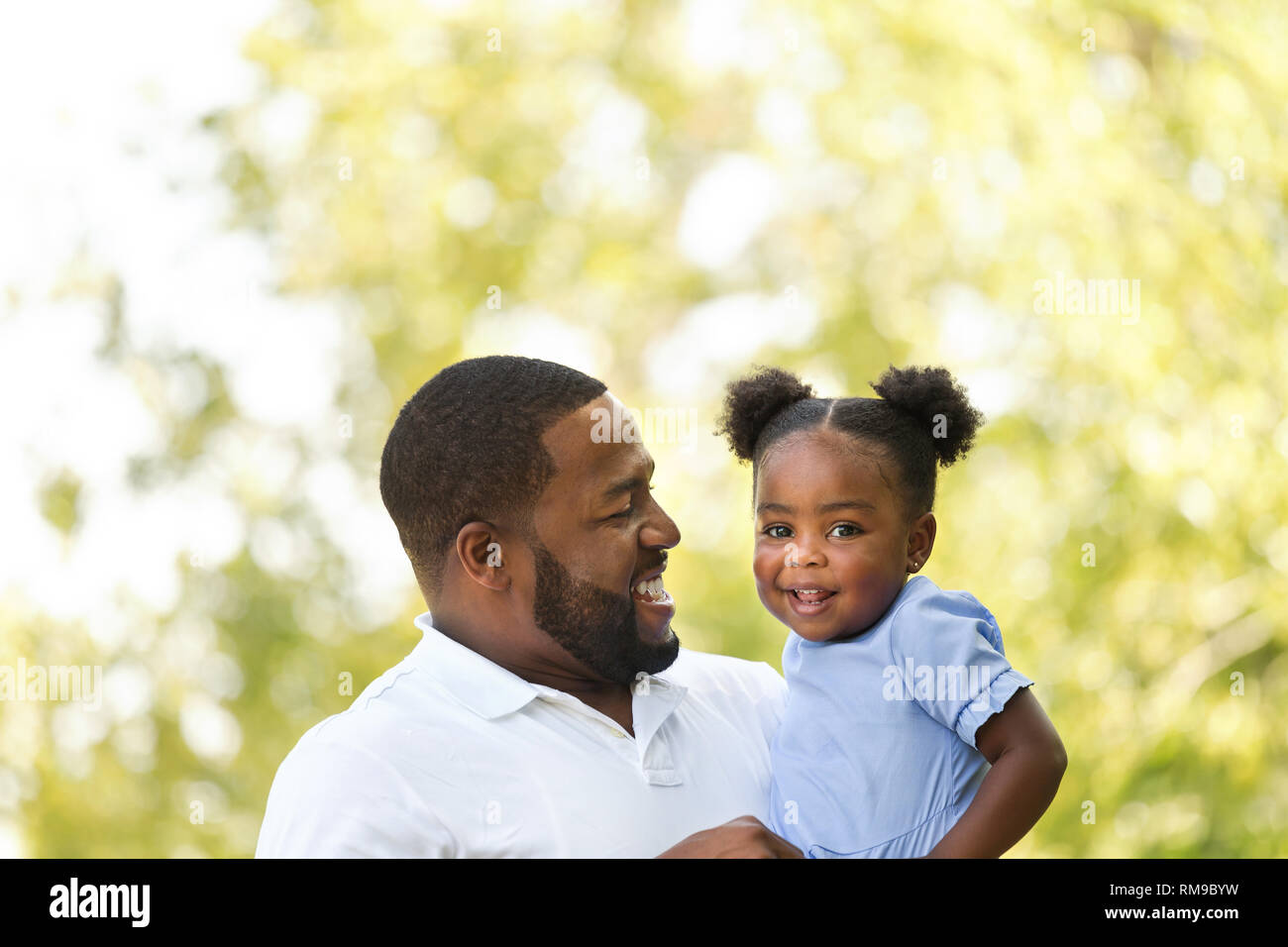 African American father holding his little girl Stock Photo - Alamy