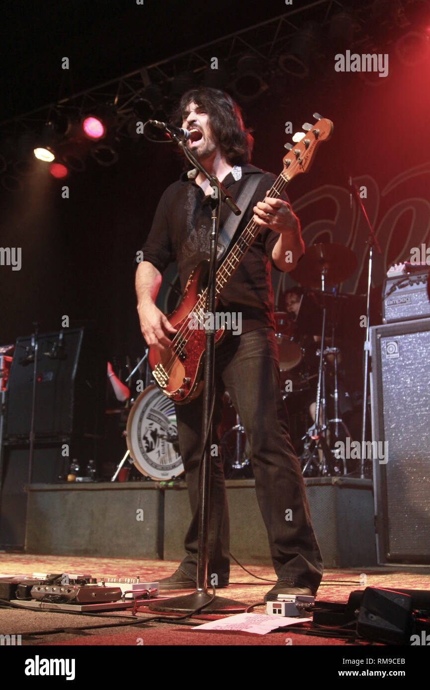Bassist and singer Adam Kury is shown performing on stage during a 'live' concert appearance with Candlebox. Stock Photo