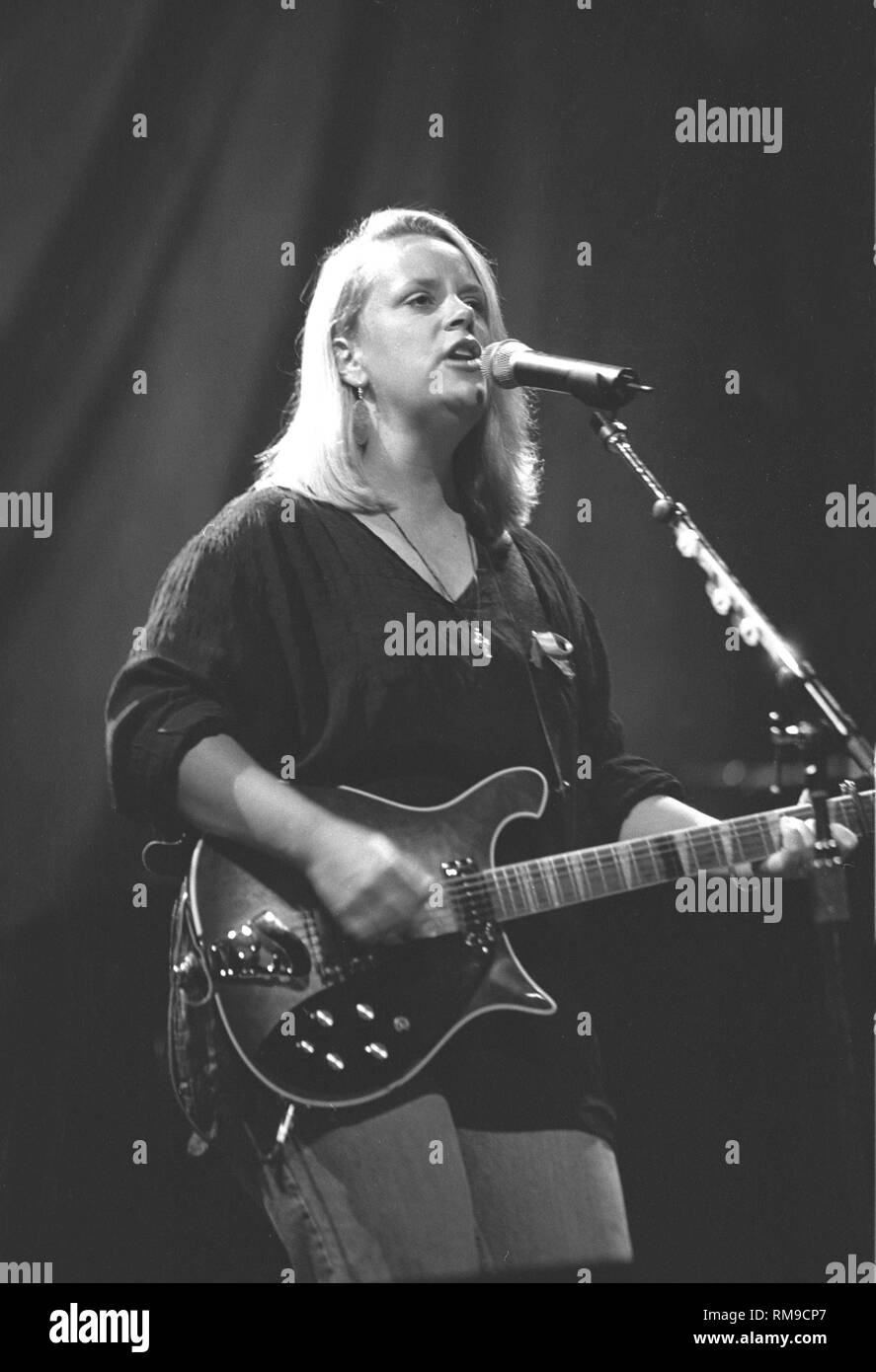 Country music artist Mary Chapin Carpenter is shown playing guitar and singing on stage during a 'live' concert appearance. Stock Photo