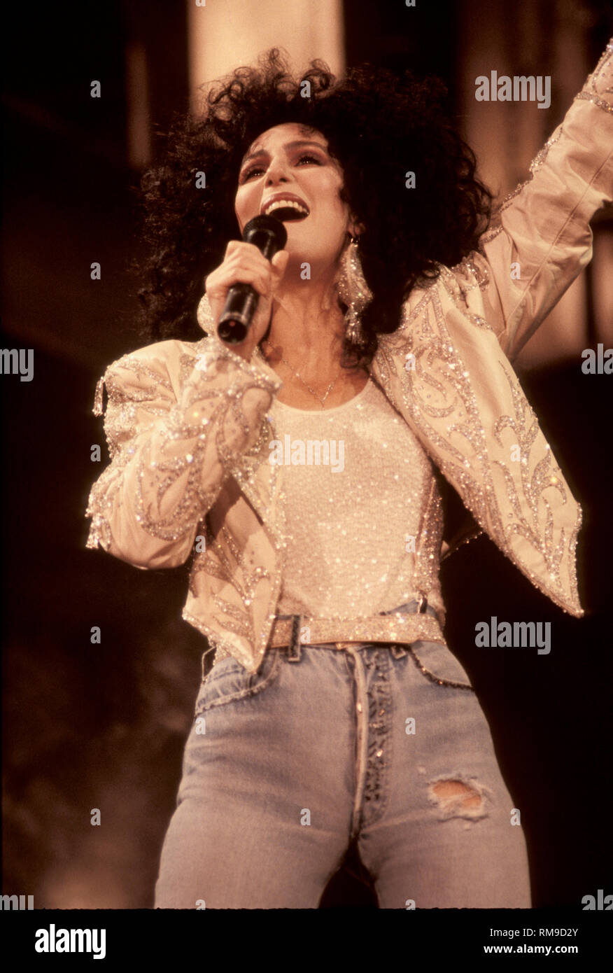 Singer, songwriter, actress and movie producer Cher, born Cherilyn Sarkisian, is shown on stage performing during a 'live' concert appearance. Stock Photo