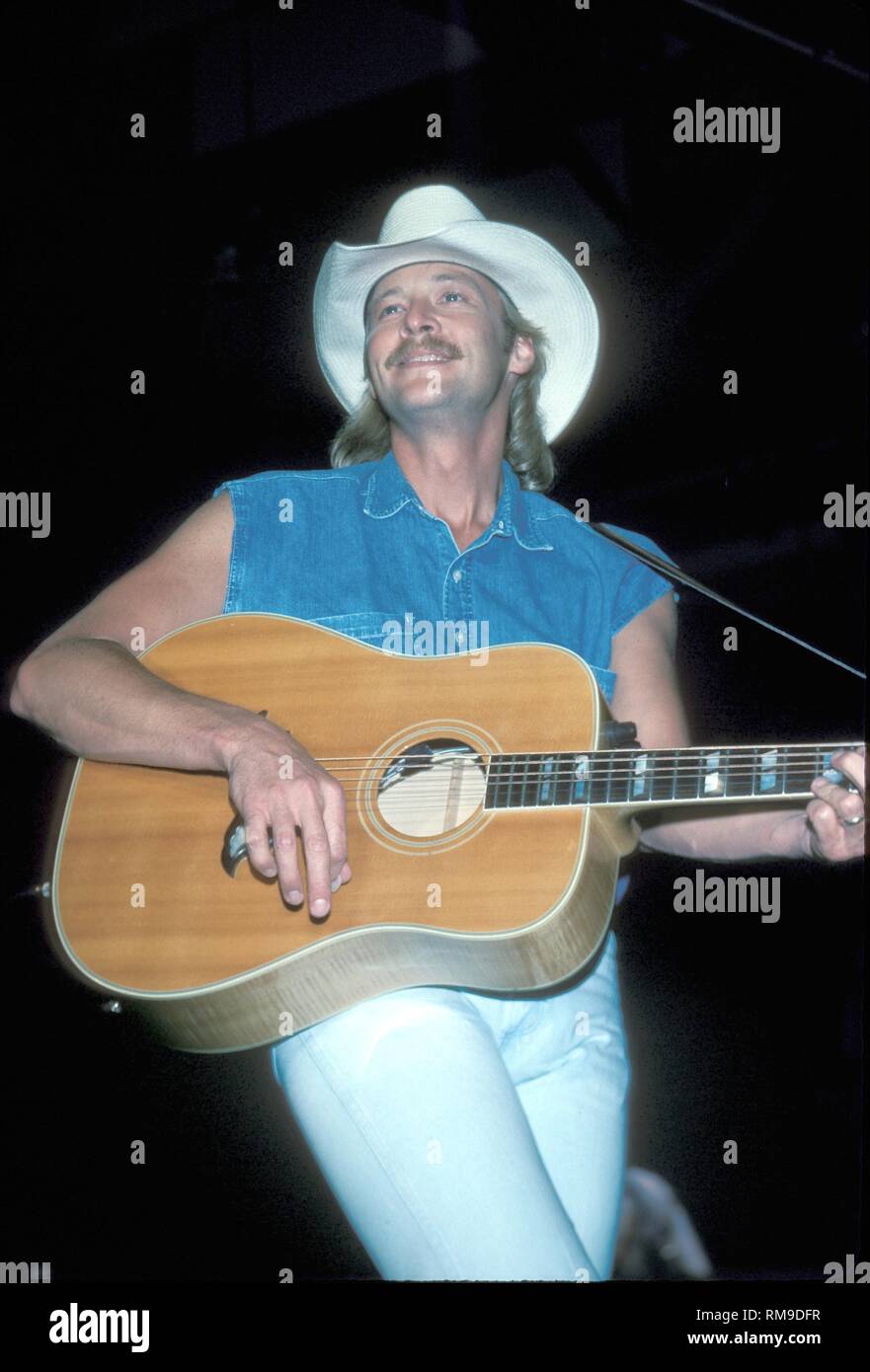 Country music star Alan Jackson is shown performing on stage with his  acoustic guitar during a "live" concert appearance Stock Photo - Alamy
