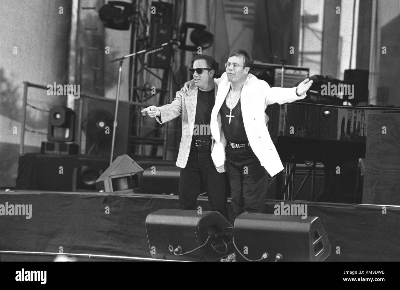 Musicians Billy Joel and Elton are shown performing on stage together during a very special 'live' concert appearance. Stock Photo