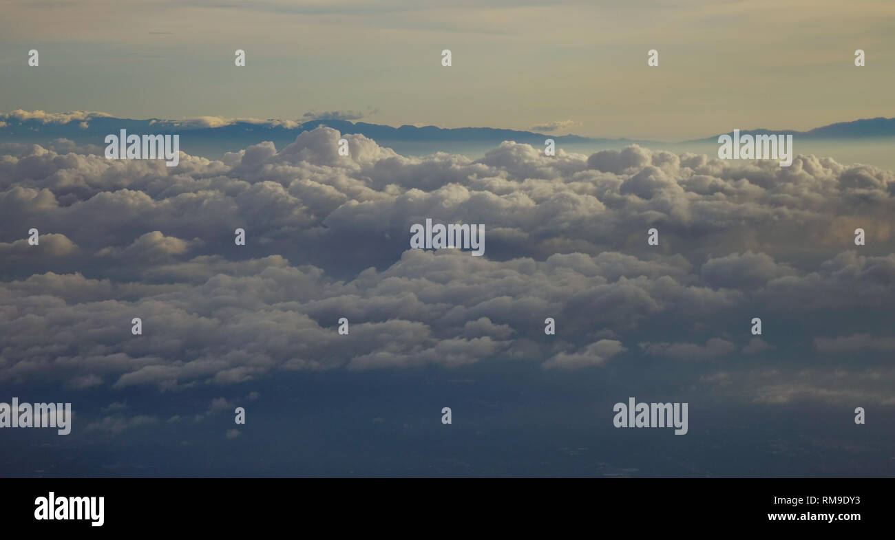 Blue sky with clouds, view from the flying airplane Stock Photo - Alamy