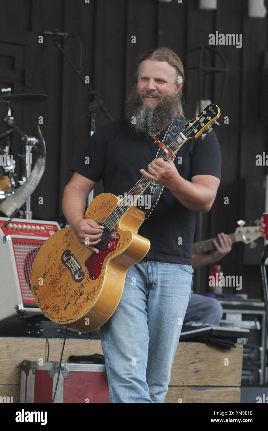 Musician Jamey Johnson is shown performing on stage during a "live