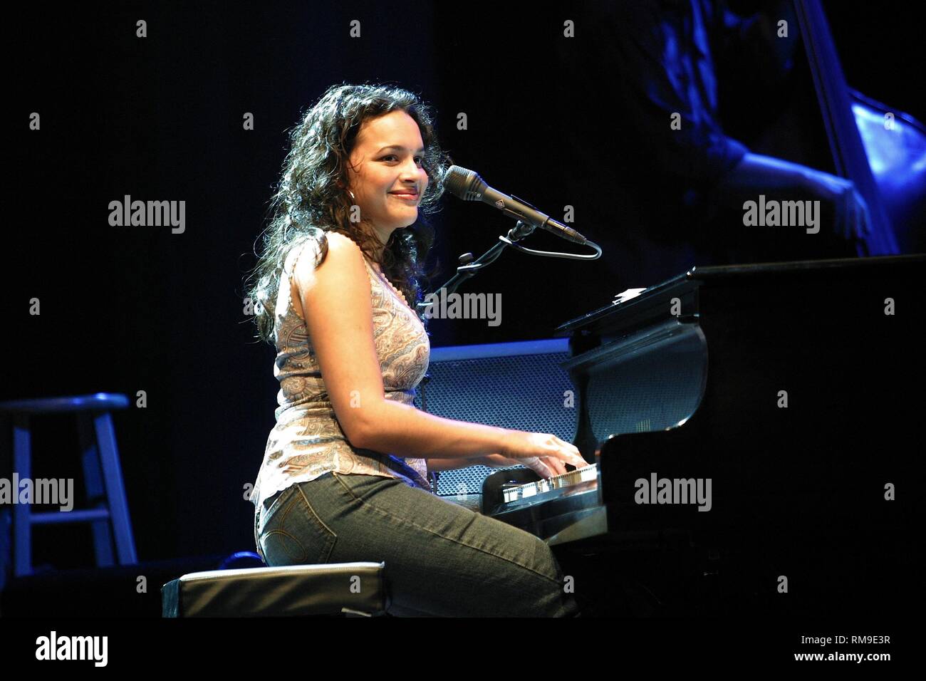Singer, songwriter, pianist, keyboardist, guitarist, and occasional actress Norah Jones is shown performing on stage during a 'live' concert appearance. Stock Photo