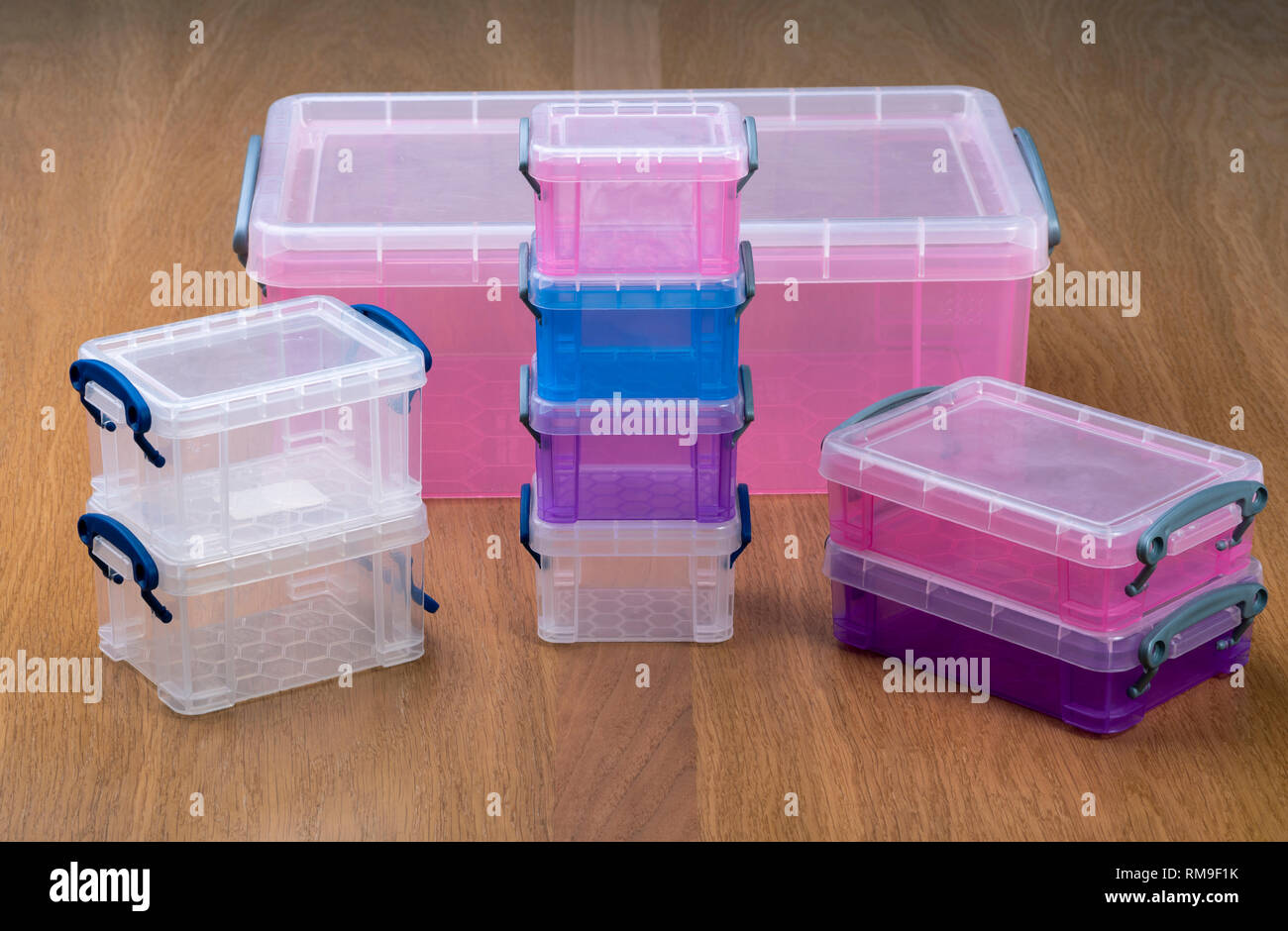 Plastic storage boxes or crates on a wooden table. Stock Photo