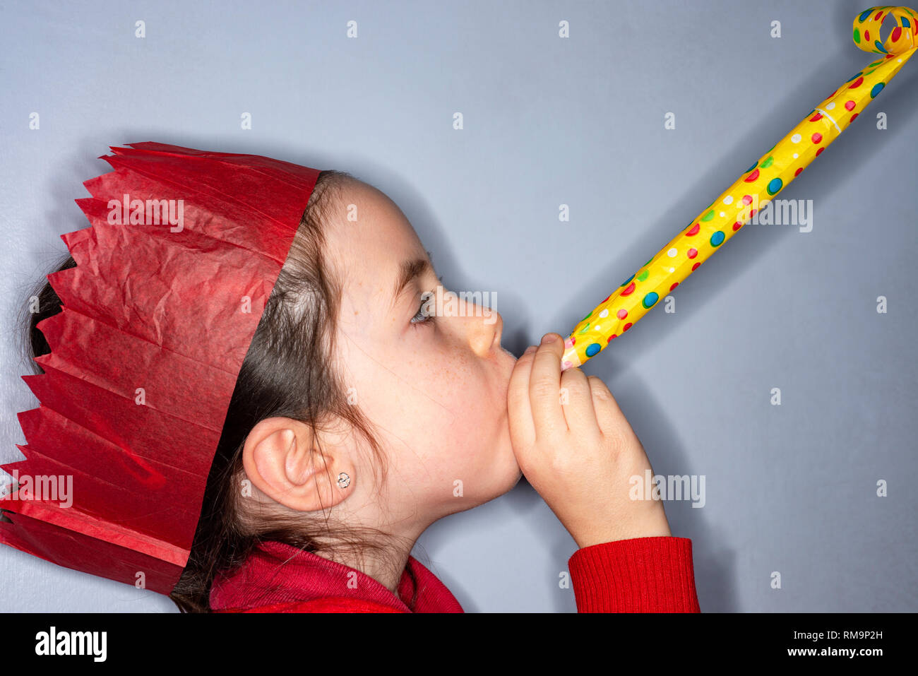 Paper hat and party blower Stock Photo - Alamy