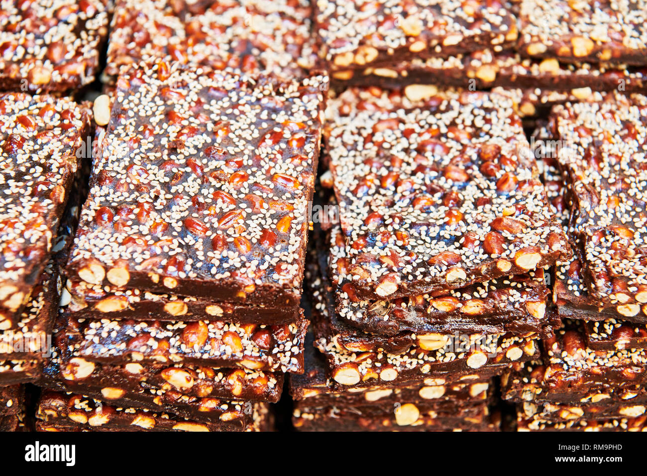 A pile of peanut brittle bars covered with sesame seeds for sale at a market in the Philippines Stock Photo