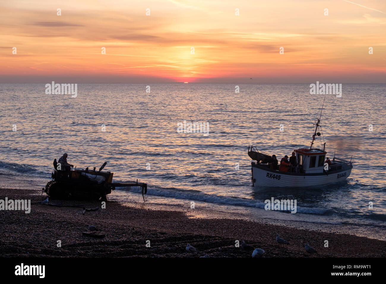 Hastings, East Sussex, UK. 14th Feb, 2019. UK Weather: Hastings fishing boat being launched at sunrise. Hastings has the largest beach-launched fishing fleet in Europe. Credit: Carolyn Clarke/Alamy Live News Stock Photo